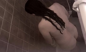 hidden-cam-films-a-busty-amateur-brunette-taking-a-shower